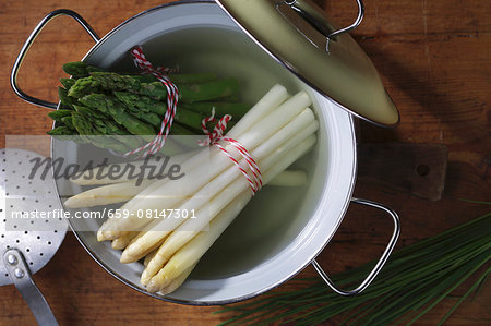 Boiled white and green asparagus in a pot