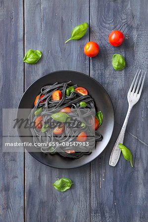 Black squid ink pasta with tomatoes and basil Black squid ink pasta with tomatoes and basil