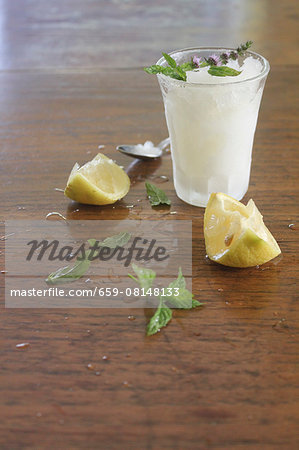 Lemon granita, lemons and fresh mint on a wooden surface Lemon granita, lemons and fresh mint on a wooden surface