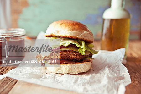 A bean veggie burger with smoked Cheddar and red onions in a brioche bun