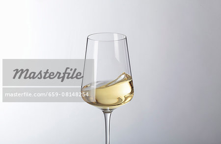 White wine swilling in a glass