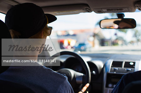 Young man behind wheel of car