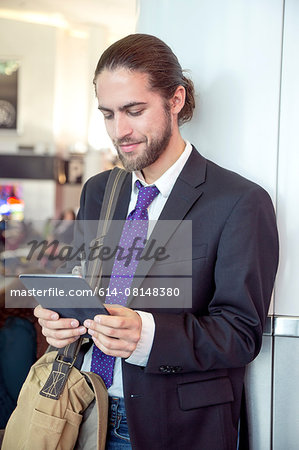 Businessman on business trip using digital tablet, New York, USA