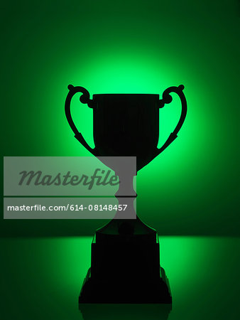 Silhouetted trophy with green background