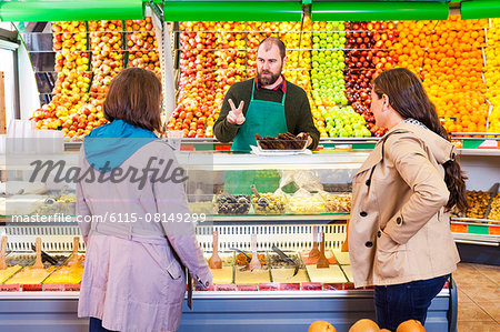 Female customers shopping in greengrocer's shop