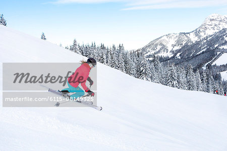 Ski holiday, Woman skiing downhill, Sudelfeld, Bavaria, Germany