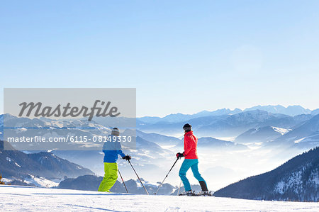 Ski holiday, Skiers overlooking mountain scenery, Sudelfeld, Bavaria, Germany