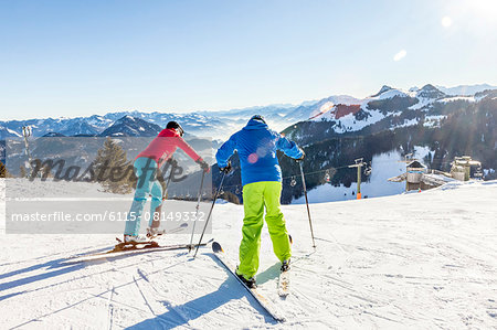 Ski holiday, Skiers overlooking mountain scenery, Sudelfeld, Bavaria, Germany