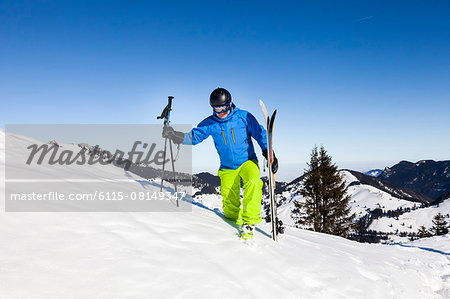 Ski holiday, Skier hiking uphill, Sudelfeld, Bavaria, Germany