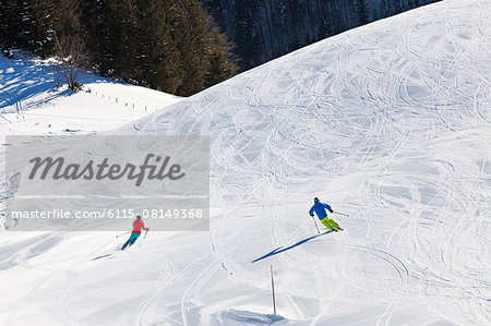 Ski holiday, Skiers carving downhill, Sudelfeld, Bavaria, Germany