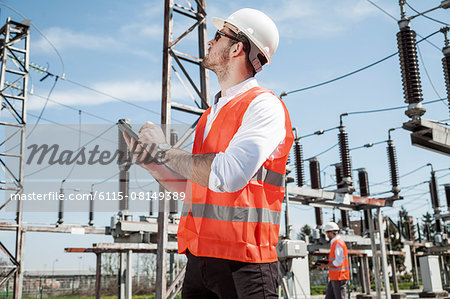 Engineers checking electricity substation