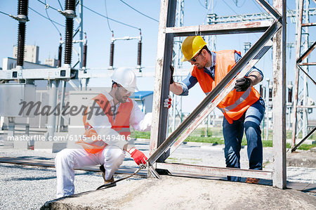 Two engineers checking electricity substation