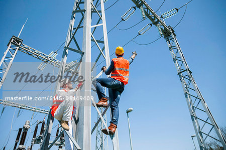 Two engineers checking electricity substation