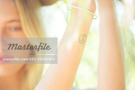 Woman with peace sign tattoo