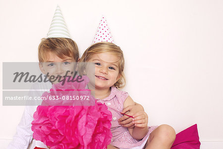 Brother and sister at birthday party, portrait