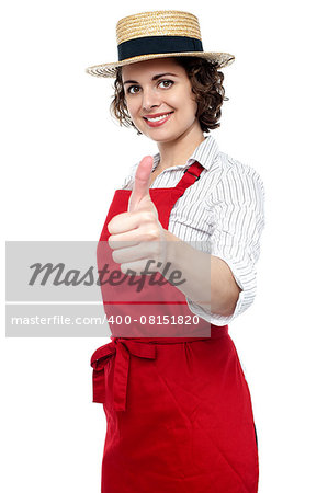 Pretty baker woman in red apron showing thumbs up gesture.