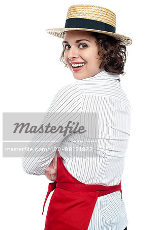 Charming female chef wearing straw bowlers hat and flashing a smile.