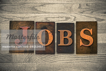 The word "JOBS" theme written in vintage, ink stained, wooden letterpress type on a wood grained background.