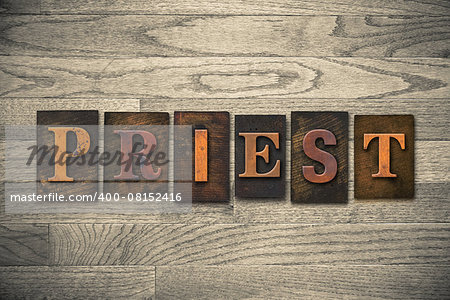 The word "PRIEST" theme written in vintage, ink stained, wooden letterpress type on a wood grained background.