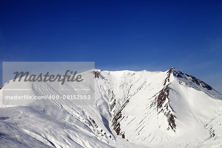 Snowy mountains in wind day. Caucasus Mountains. Georgia, ski resort Gudauri.