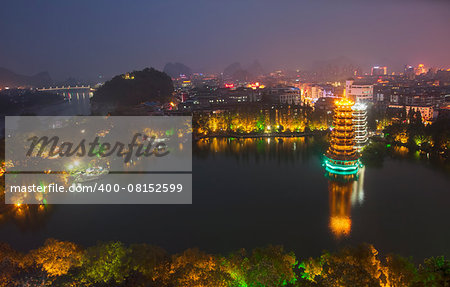 Evening view of the Gold and Silver Pagodas, also known as the Sun and Moon Pagodas, reflected in Shan Lake  Guilin, Guangxi Province, China.