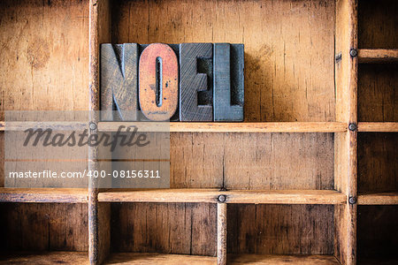 The word NOEL written in vintage wooden letterpress type in a wooden type drawer.