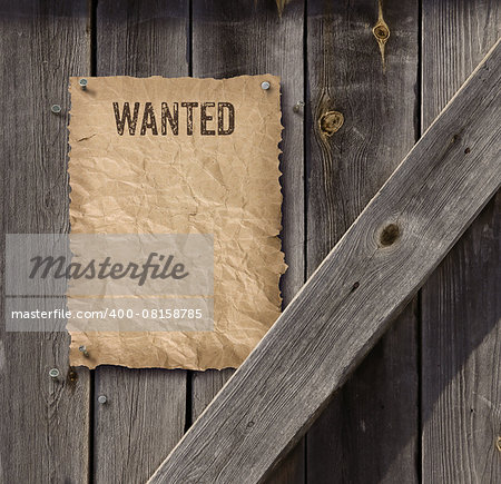 Wild West style wanted poster on weathered plank wood door