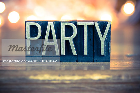 The word PARTY written in vintage metal letterpress type on a soft backlit background.