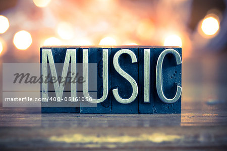 The word MUSIC written in vintage metal letterpress type on a soft backlit background.