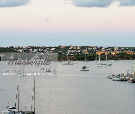 Various Anchor Yachts and Beautiful Sundown in Marina Harbor, Mahon, Menorca, Balearic Islands