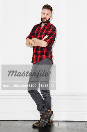 Young man wearing checked shirt, studio shot