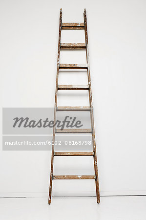 Ladder against white wall