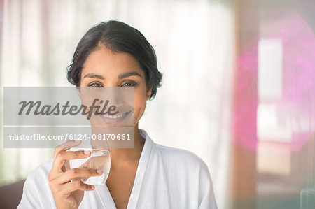 Portrait smiling woman drinking water