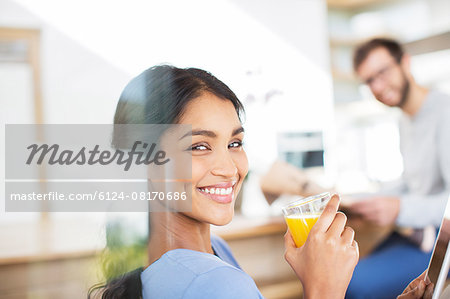 Portrait smiling woman drinking orange juice