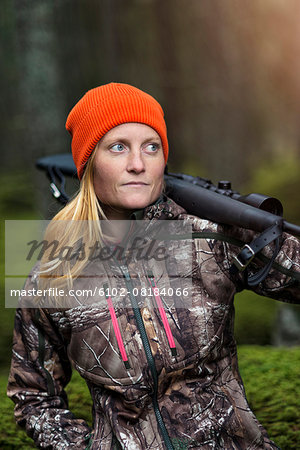 Woman hunting in forest