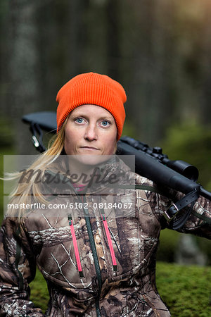 Woman hunting in forest