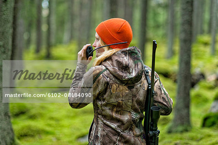 Woman hunting in forest