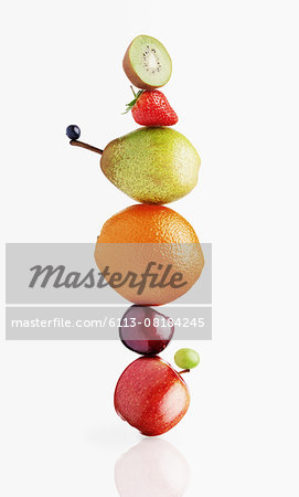 Stacked fruit on white background