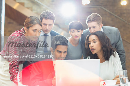 Business people working at laptop in office