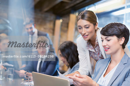 Businesswomen working with digital tablet in conference room meeting