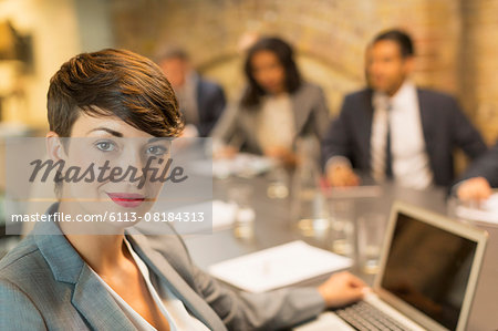 Portrait confident businesswoman with laptop in meeting