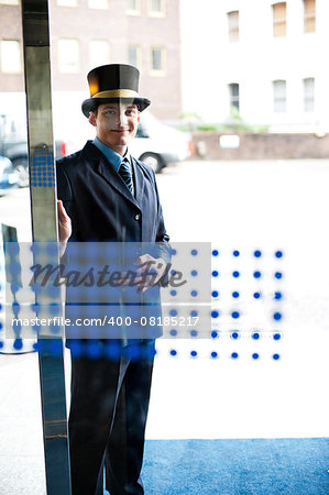 Hotel doorman at your service. Buildings and cars in the background