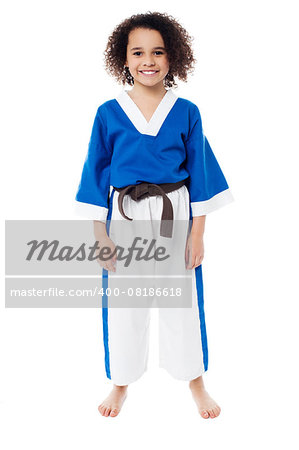 Young girl in karate uniform getting ready for practice
