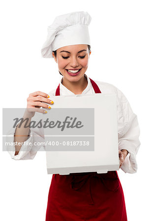 Isolated female chef on white background opening pizza box.