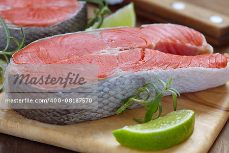 Raw red salmon steaks on a cutting board