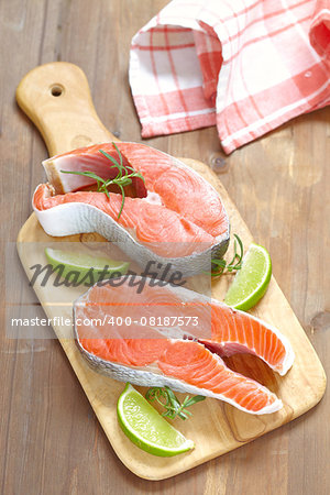 Raw red salmon steaks on a cutting board