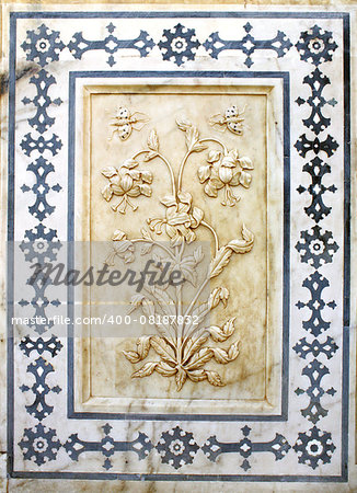 Ancient carved flower on marble in Amber Fort near Jaipur, Rajasthan, India