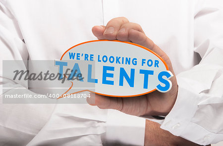 Man holding a comics bubble with the text we are looking for talents. Concept image for illustration of talent recruitment or job opportunities.