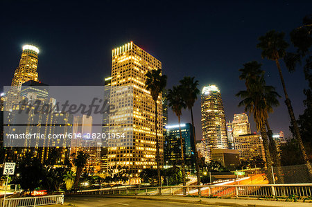 View of highway and city skyline at night, Los Angeles, California, USA