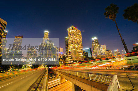 View of city skyscrapers and highway at night, Los Angeles, California, USA View of city skyscrapers and highway at night, Los Angeles, California, USA